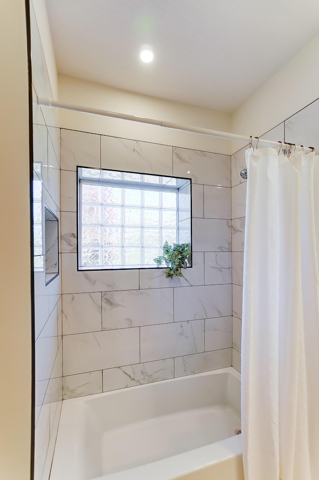 bathroom with shower / bathtub combination with curtain