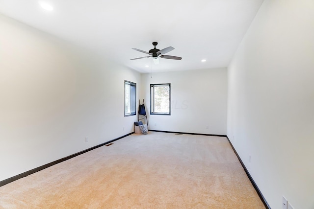 unfurnished room with light carpet and ceiling fan