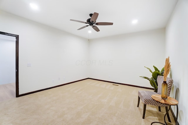 carpeted spare room featuring ceiling fan