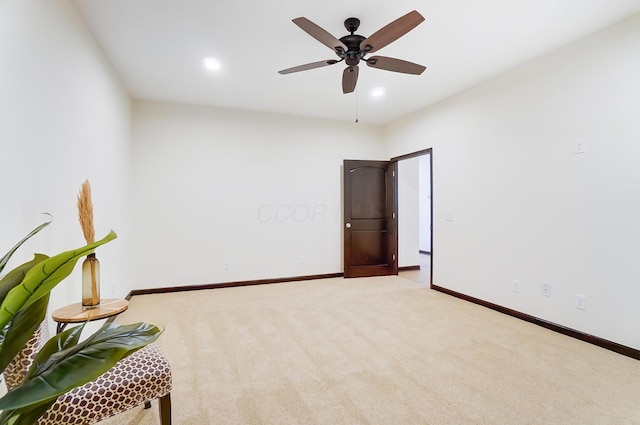 carpeted spare room with ceiling fan