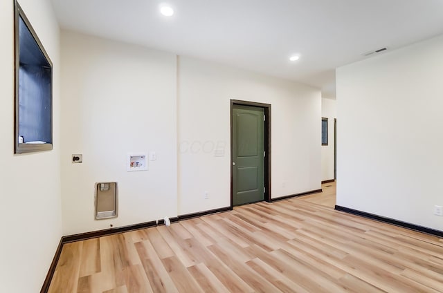 empty room with light hardwood / wood-style flooring