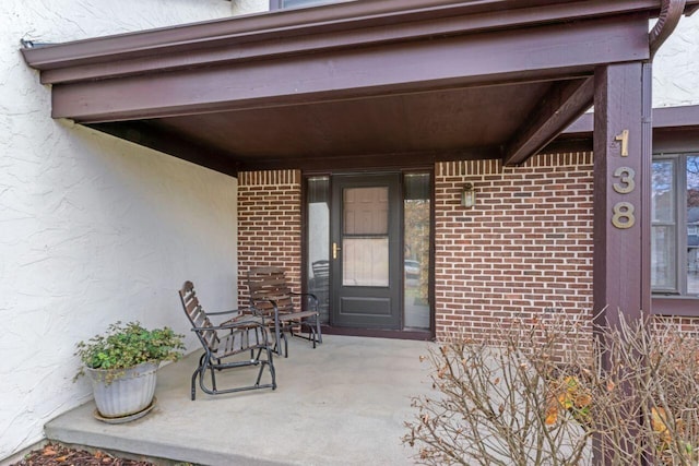 view of exterior entry featuring a porch