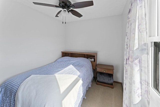 bedroom featuring multiple windows, carpet floors, and ceiling fan