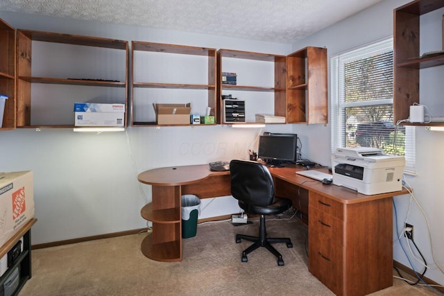 carpeted office space featuring a textured ceiling