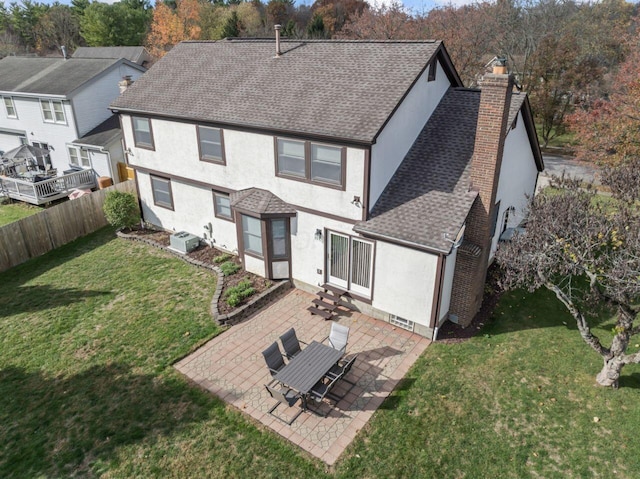 rear view of house featuring a yard and a patio