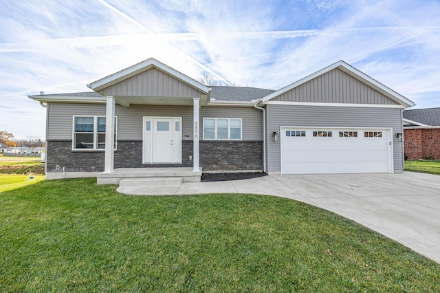 view of front of home featuring a front lawn and a garage