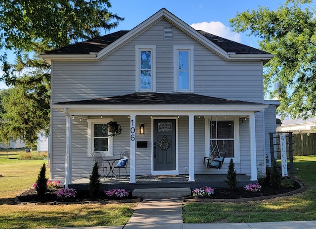 front facade with covered porch and a front lawn