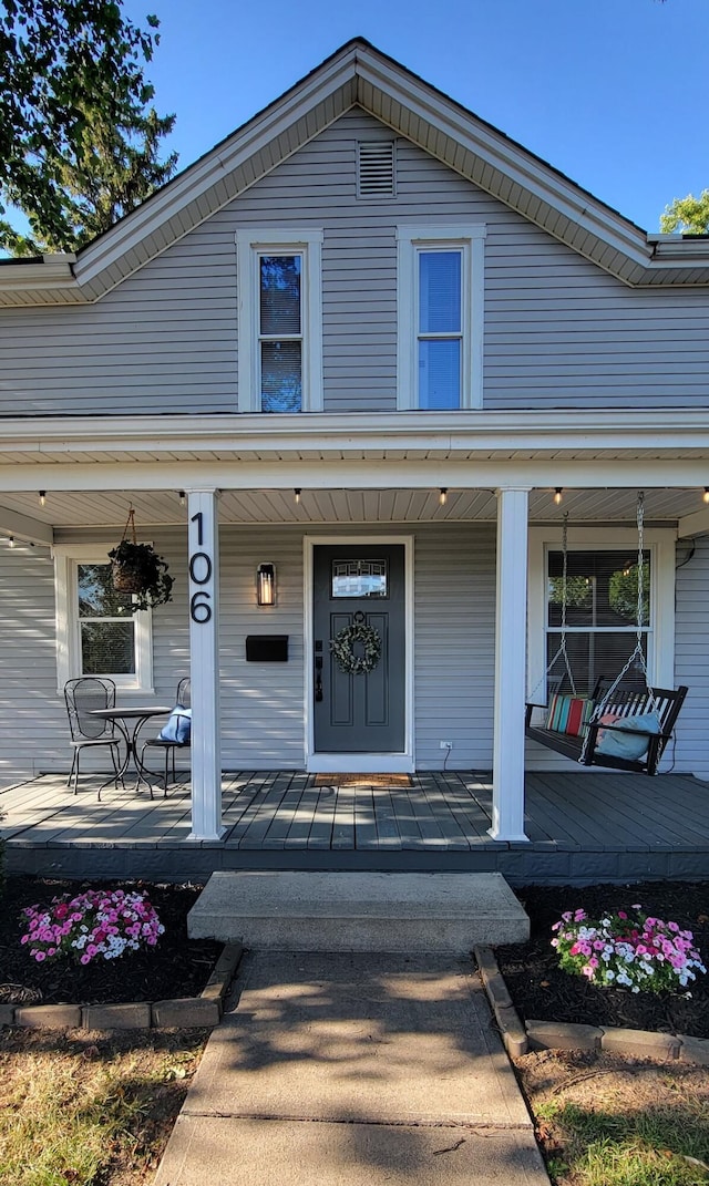 view of exterior entry with covered porch