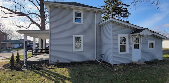 rear view of property featuring a porch and a yard