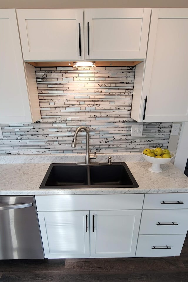 kitchen featuring dishwasher, white cabinets, and sink