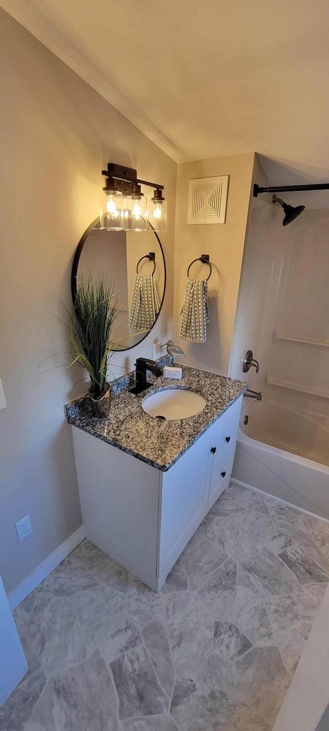 bathroom featuring bathtub / shower combination and vanity