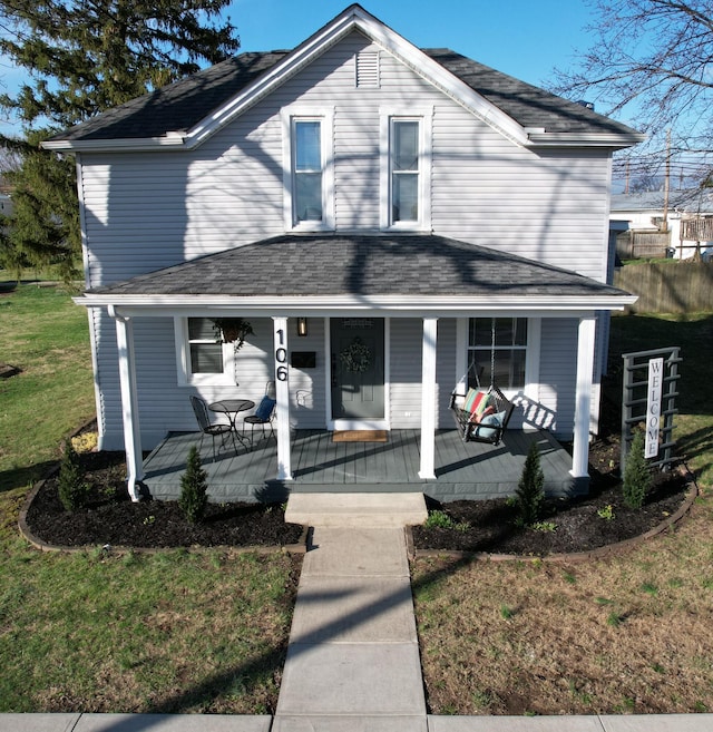 view of front of home featuring covered porch and a front yard