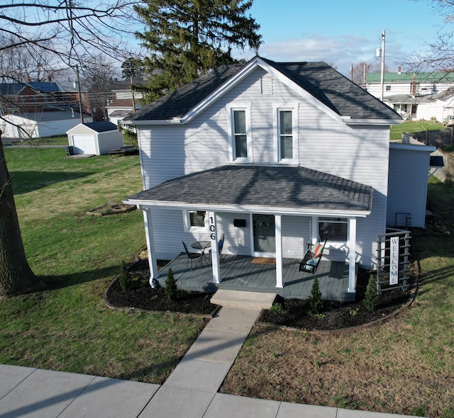 view of front of property featuring an outdoor structure, a wooden deck, and a front yard