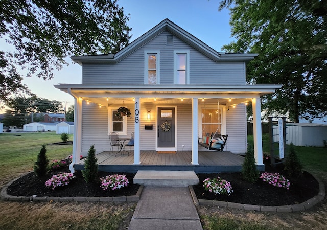 view of front facade with a lawn and a porch