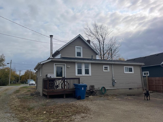 back of house featuring a deck