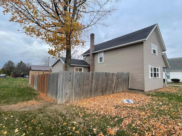 view of side of home featuring a yard