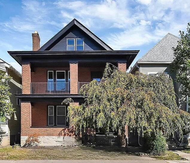 back of property featuring a balcony