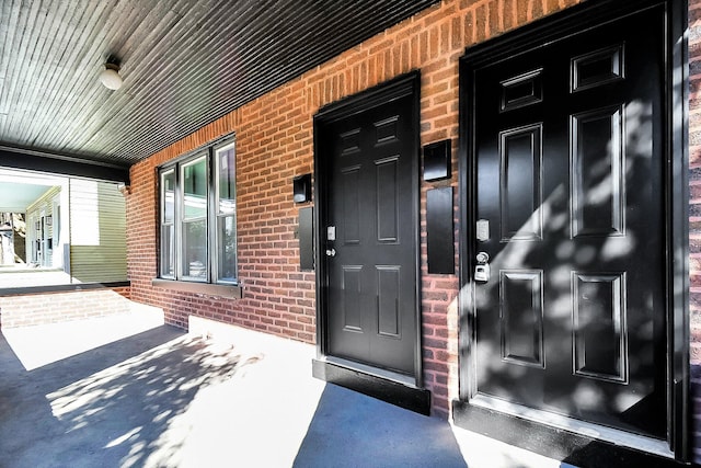 view of exterior entry with covered porch