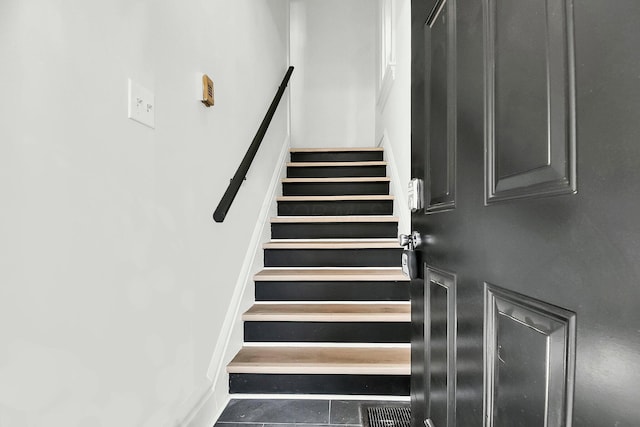 stairs featuring tile patterned flooring