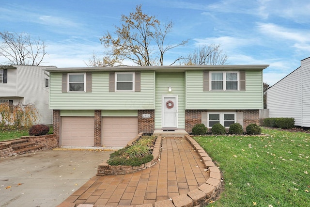 raised ranch featuring a front lawn and a garage