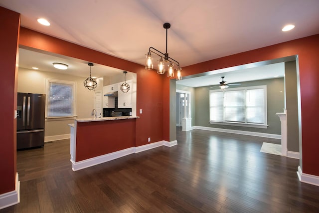 kitchen with ceiling fan, dark wood-type flooring, decorative light fixtures, white cabinets, and stainless steel fridge with ice dispenser