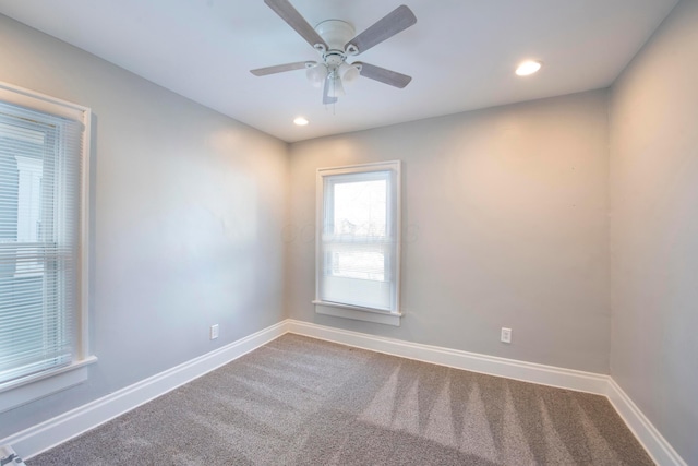 carpeted spare room with ceiling fan