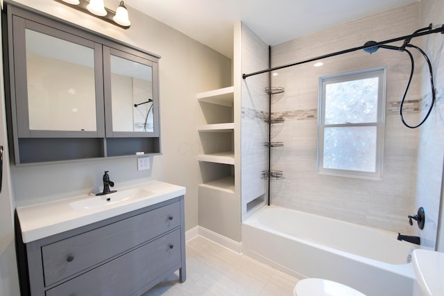 full bathroom with vanity, tiled shower / bath combo, and toilet