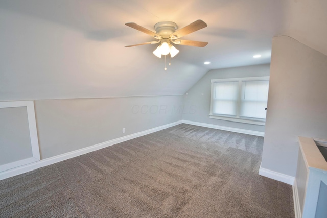 additional living space featuring carpet flooring, ceiling fan, and vaulted ceiling