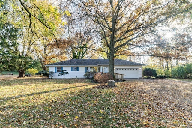 ranch-style house with a front yard and a garage