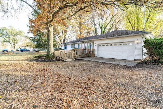 view of front of property featuring a garage and a wooden deck