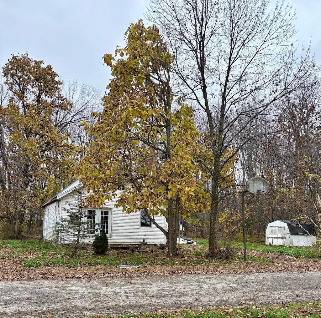 view of property exterior with a shed