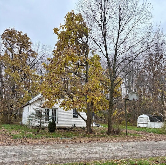 view of property exterior with a shed