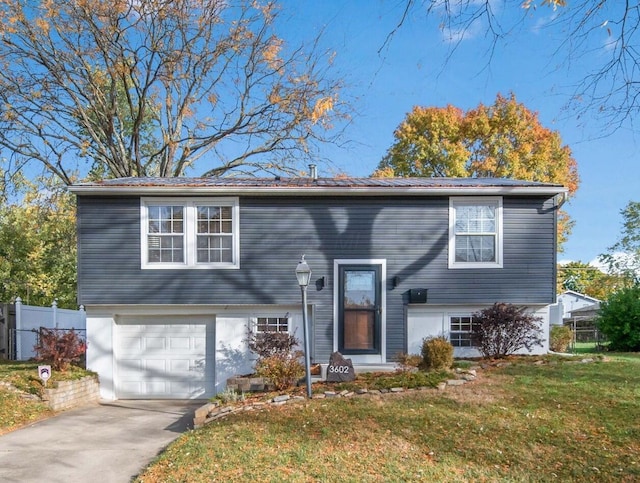 split foyer home with a front yard and a garage