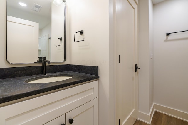 bathroom with hardwood / wood-style flooring and vanity