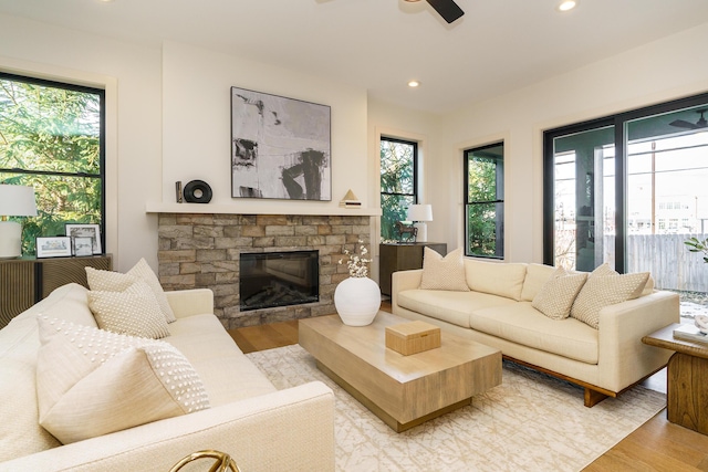 living room with ceiling fan, light hardwood / wood-style floors, and a wealth of natural light