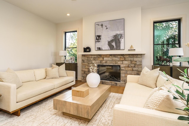 living room featuring light wood-type flooring and a fireplace