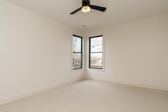 unfurnished room with ceiling fan and carpet floors