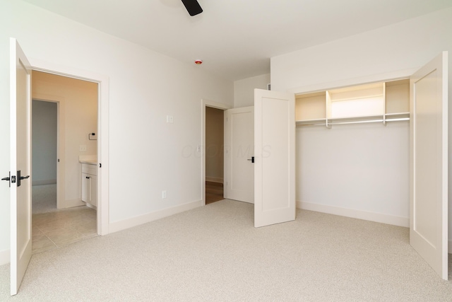 unfurnished bedroom with a closet, ceiling fan, and carpet flooring