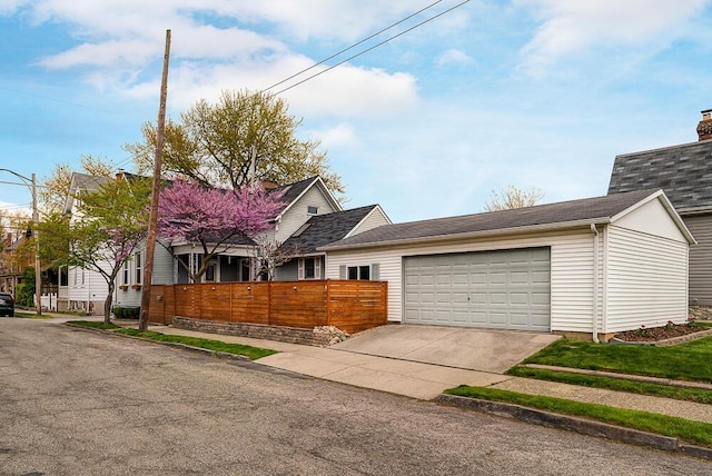 ranch-style home with concrete driveway, roof with shingles, and an attached garage