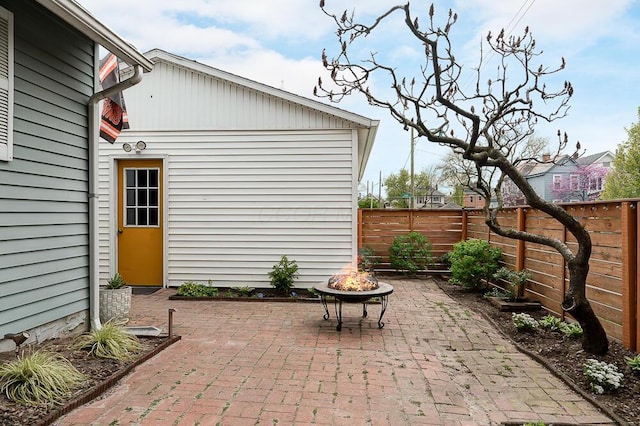 view of patio with an outdoor fire pit and a fenced backyard