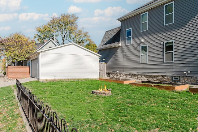 view of yard with an outdoor fire pit and fence