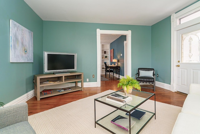 living room featuring baseboards and wood finished floors