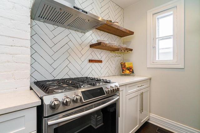 kitchen featuring gas stove, white cabinets, ventilation hood, and open shelves