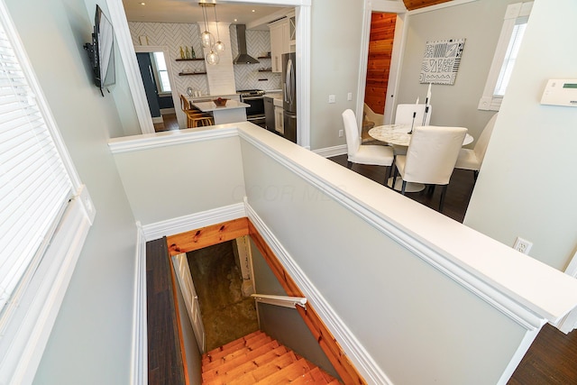 stairs featuring baseboards and wood finished floors