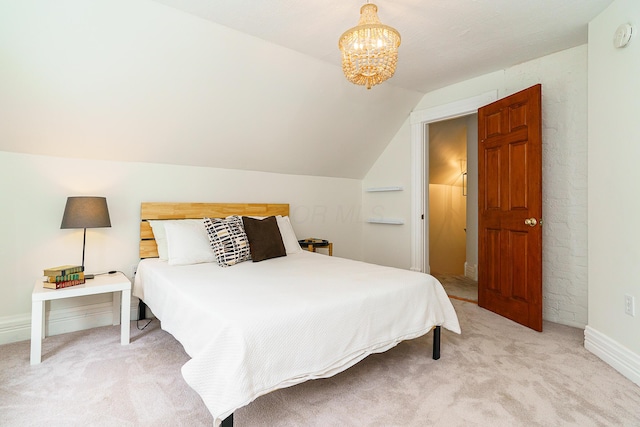 bedroom with lofted ceiling, a notable chandelier, and light colored carpet