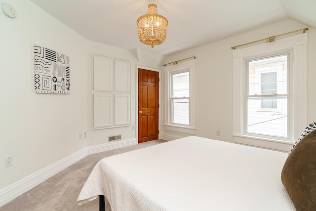 bedroom featuring lofted ceiling, baseboards, visible vents, and light colored carpet