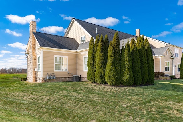 view of property exterior featuring cooling unit and a lawn