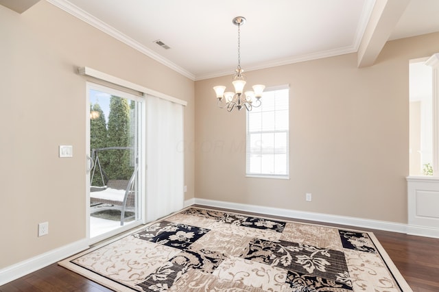 dining room with an inviting chandelier, dark hardwood / wood-style flooring, and ornamental molding