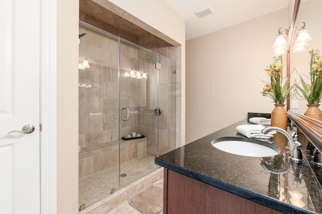 bathroom with walk in shower and vanity