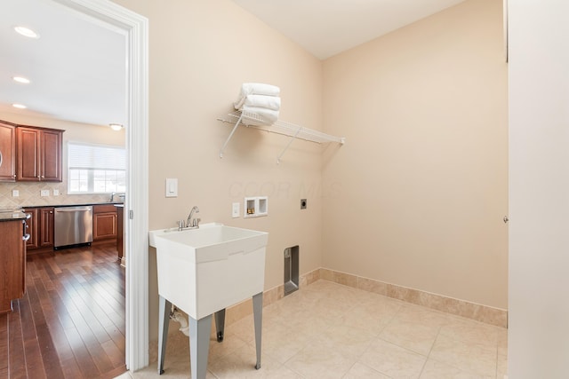 washroom featuring hookup for an electric dryer, sink, and washer hookup